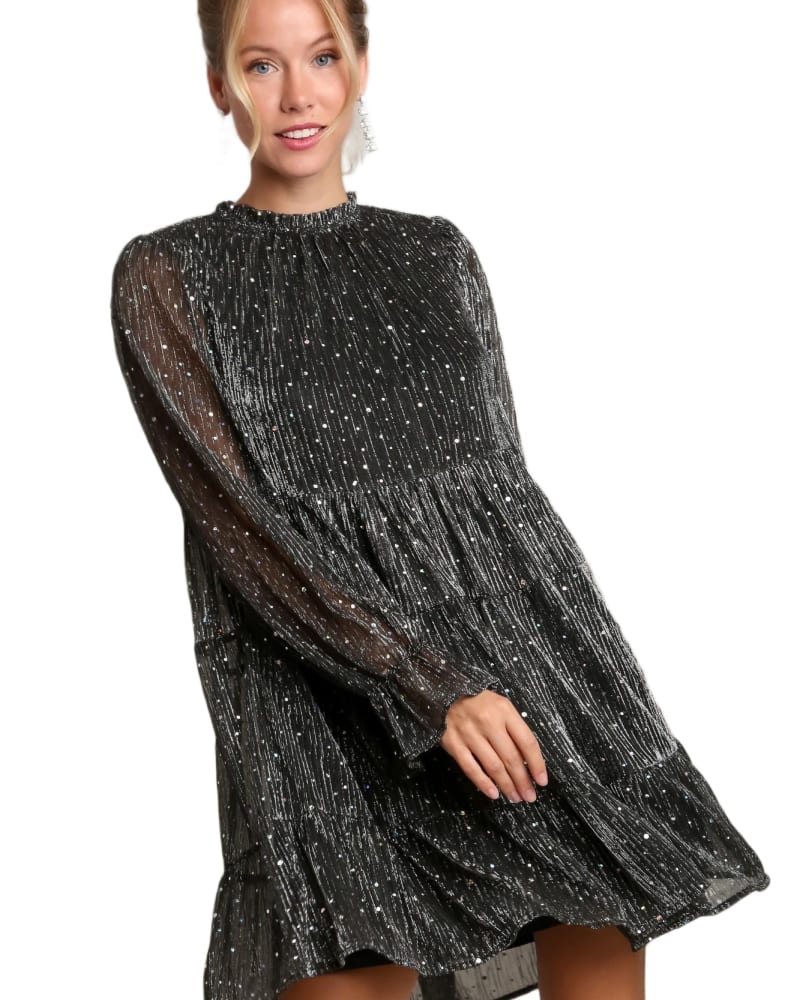Front of a model wearing a size L Metallic Pleats Shimmer Tiered Dress in Black by Très Chic. | dia_product_style_image_id:321812
